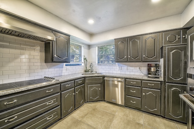 kitchen featuring dark brown cabinetry, dishwasher, black cooktop, decorative backsplash, and sink