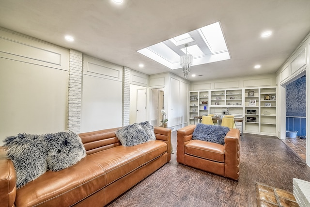 living room featuring built in shelves and a notable chandelier