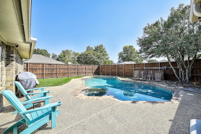 view of swimming pool featuring an in ground hot tub and a patio