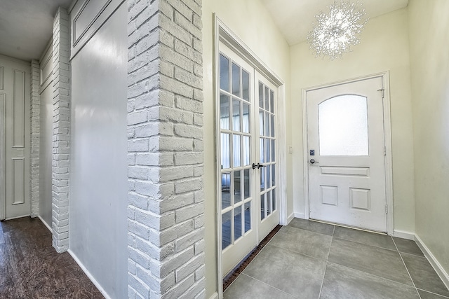 entrance foyer with an inviting chandelier and french doors