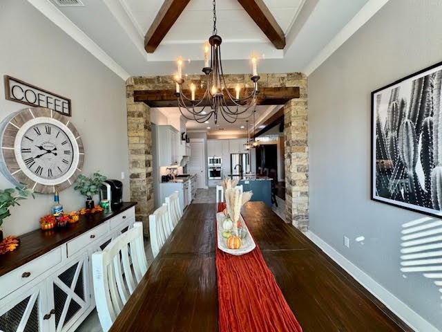 dining space with an inviting chandelier, beamed ceiling, and dark wood-type flooring