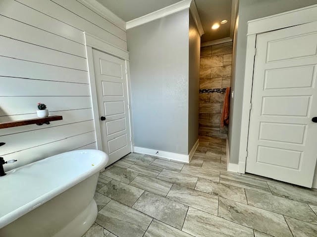 bathroom with a bath and ornamental molding