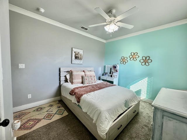 carpeted bedroom featuring crown molding and ceiling fan