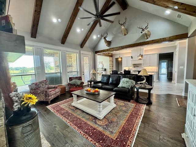 living room with ceiling fan, beamed ceiling, dark hardwood / wood-style floors, and high vaulted ceiling