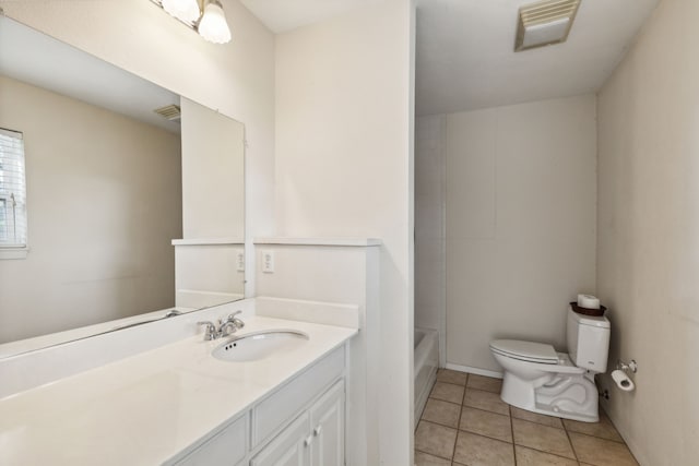 bathroom featuring vanity, toilet, and tile patterned floors