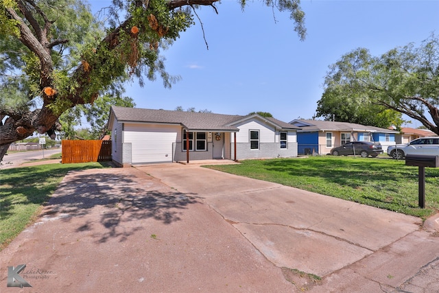 single story home featuring a front yard and a garage