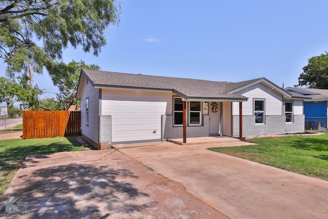 single story home with a front yard and a garage