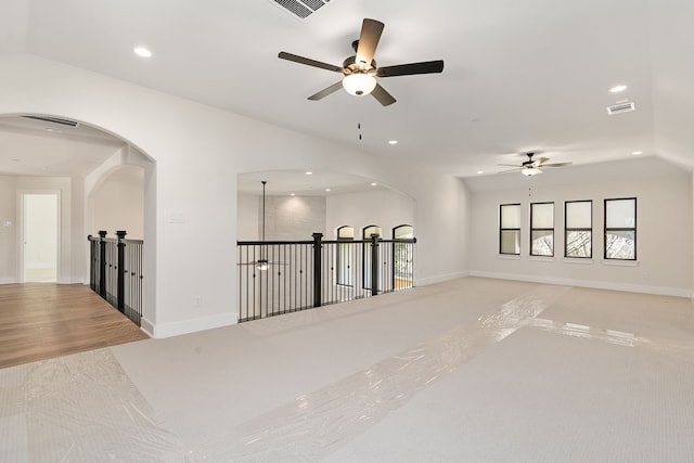 empty room with lofted ceiling, baseboards, and recessed lighting