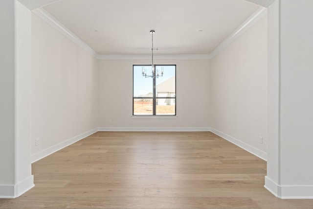 unfurnished dining area with ornamental molding, a notable chandelier, light wood-style flooring, and baseboards