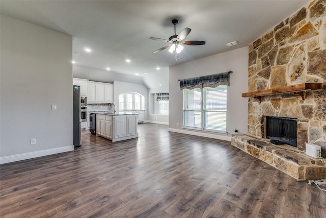 kitchen featuring white cabinetry, sink, stainless steel appliances, and an island with sink