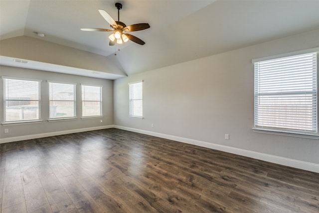 spare room with dark wood-type flooring, ceiling fan, and vaulted ceiling