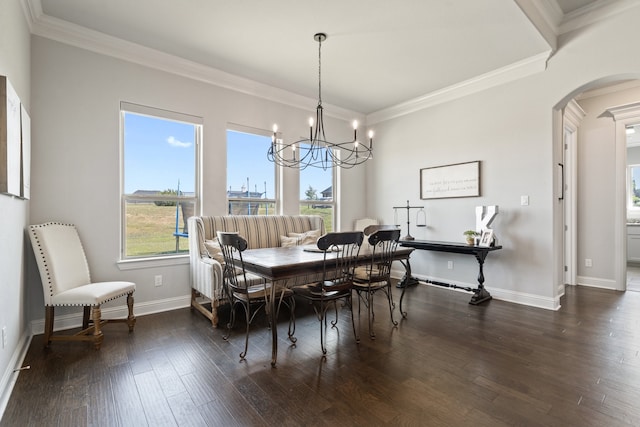 dining area featuring a notable chandelier, dark wood-type flooring, and ornamental molding