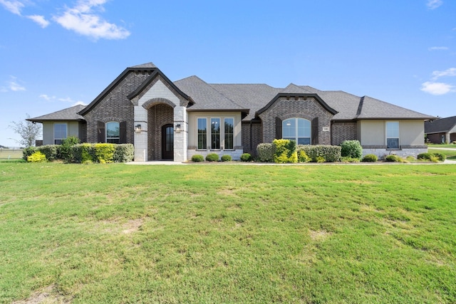 french country style house with a front yard