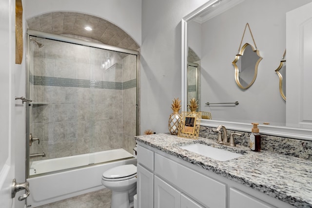 full bathroom with toilet, enclosed tub / shower combo, tile patterned floors, and vanity