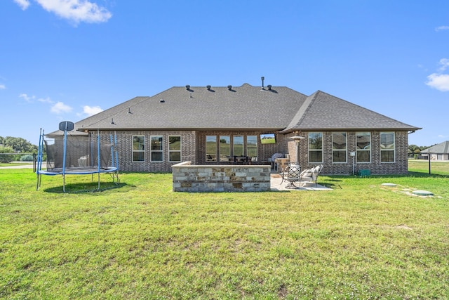 rear view of house featuring a patio and a lawn