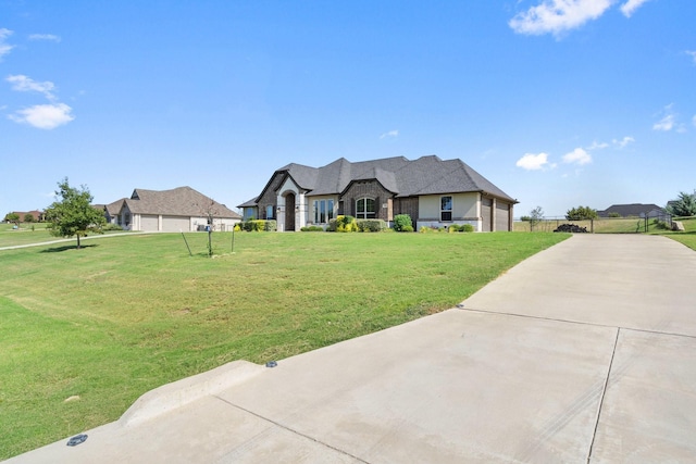 view of front of home with a front lawn and a garage