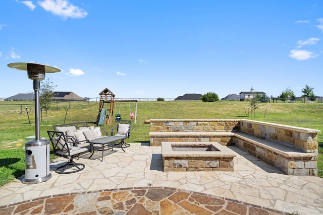 view of patio with an outdoor fire pit and a playground