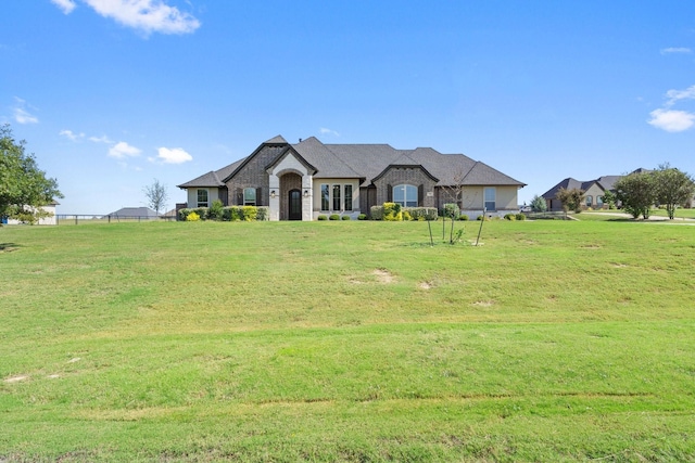 french country home with a front lawn