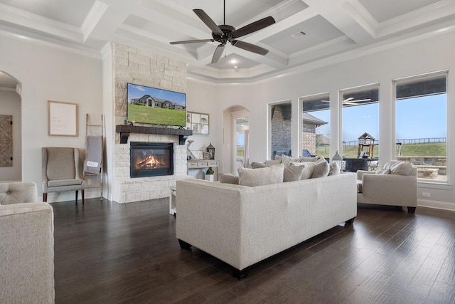 living room featuring coffered ceiling, a fireplace, ornamental molding, and ceiling fan