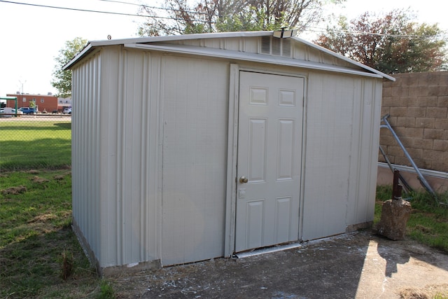 view of outbuilding featuring a lawn