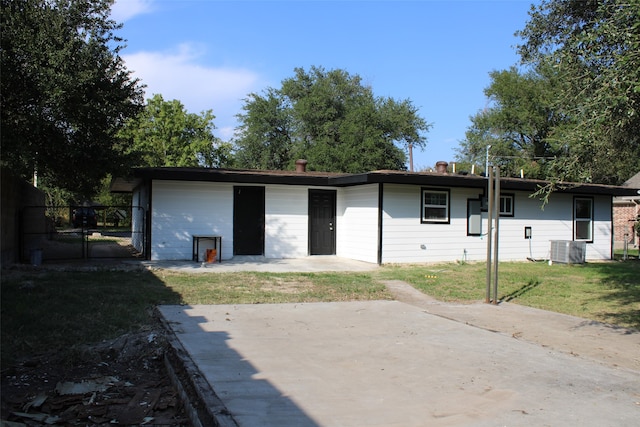 back of house featuring a lawn, a patio area, and central air condition unit