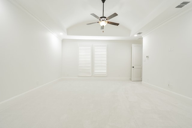 empty room with crown molding, light colored carpet, ceiling fan, and vaulted ceiling