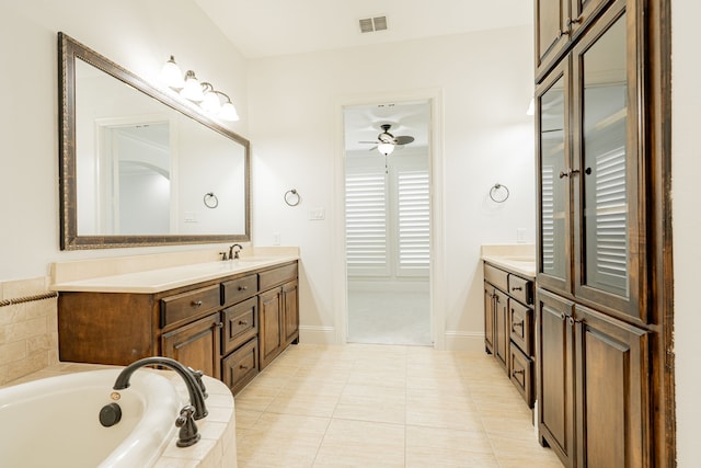 bathroom with vanity, a relaxing tiled tub, tile patterned floors, and ceiling fan