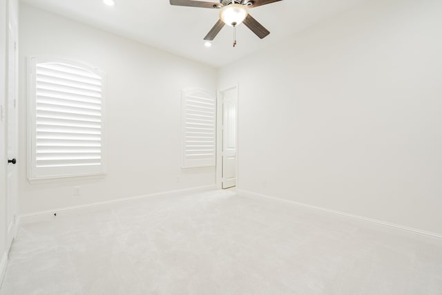 unfurnished room with light carpet and ceiling fan