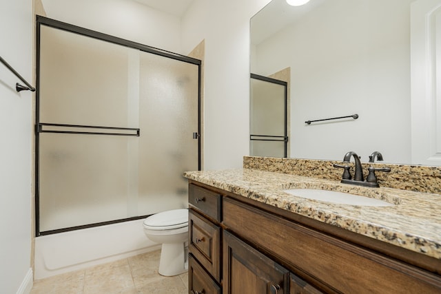 full bathroom featuring vanity, tile patterned flooring, shower / bath combination with glass door, and toilet