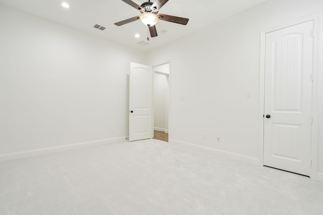 unfurnished bedroom featuring light colored carpet and ceiling fan