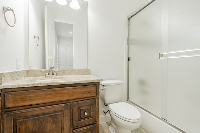 full bathroom featuring vanity, toilet, and combined bath / shower with glass door