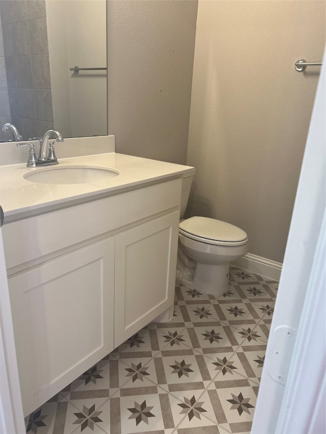 bathroom featuring vanity, toilet, and tile patterned floors