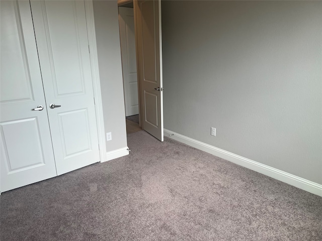 unfurnished bedroom with a closet and carpet floors