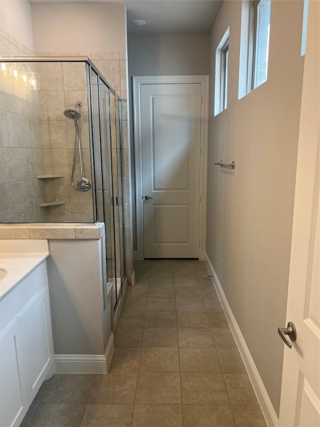 bathroom featuring vanity, an enclosed shower, and tile patterned flooring