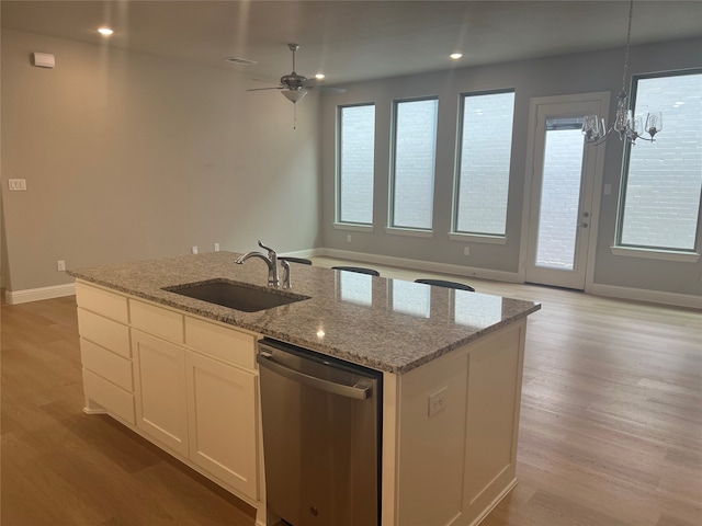 kitchen featuring a center island with sink, dishwasher, white cabinets, and light hardwood / wood-style floors