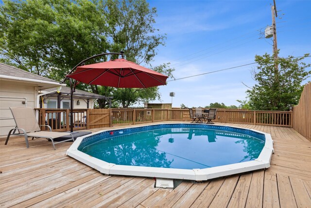 view of swimming pool featuring a wooden deck