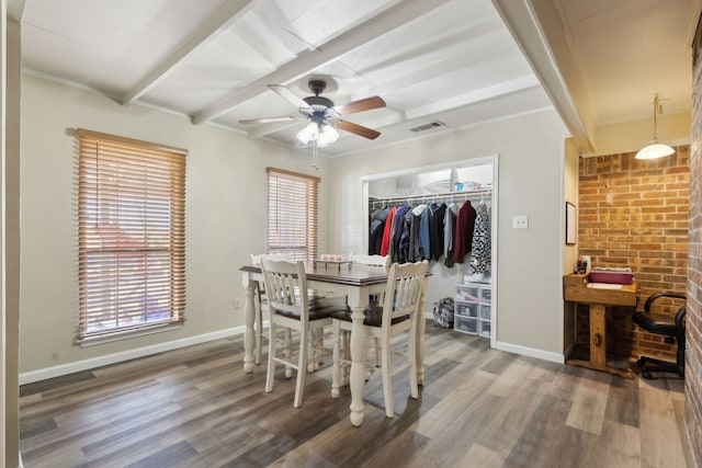 dining space featuring visible vents, beamed ceiling, baseboards, and wood finished floors