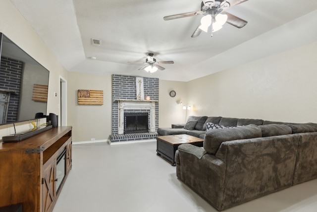 living room featuring baseboards, a fireplace, visible vents, and a ceiling fan