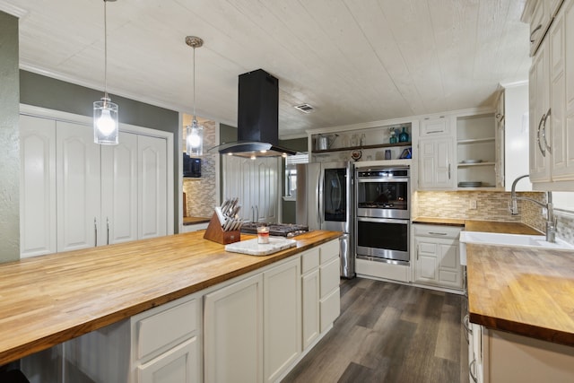 kitchen featuring island exhaust hood, open shelves, stainless steel appliances, white cabinetry, and wood counters