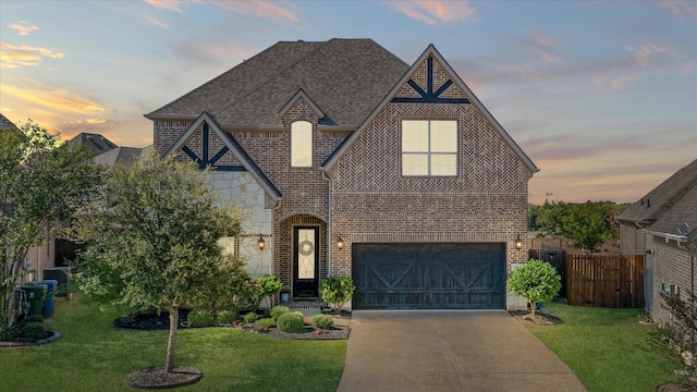 view of front of home featuring a garage and a yard