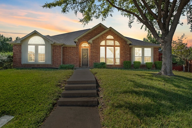 ranch-style home with a lawn