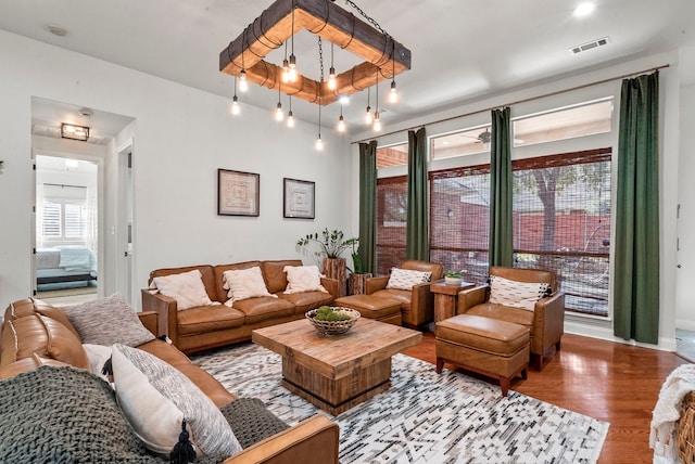 living room featuring a notable chandelier and hardwood / wood-style flooring