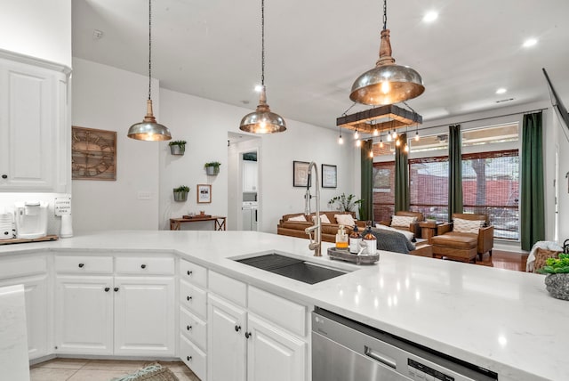 kitchen featuring pendant lighting, sink, white cabinets, and stainless steel dishwasher