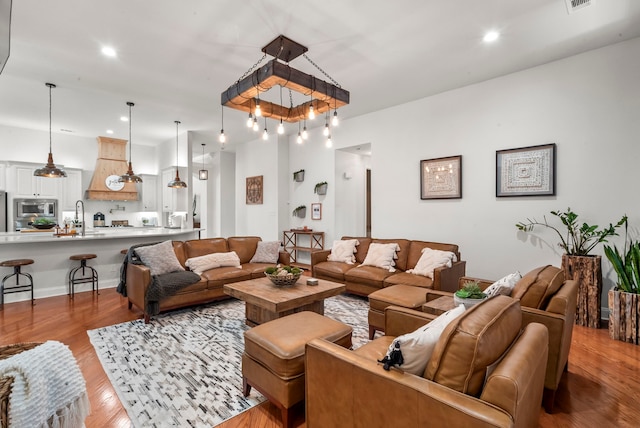 living room featuring light hardwood / wood-style flooring and sink