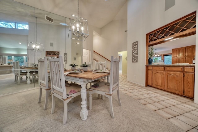 dining room with light colored carpet and high vaulted ceiling