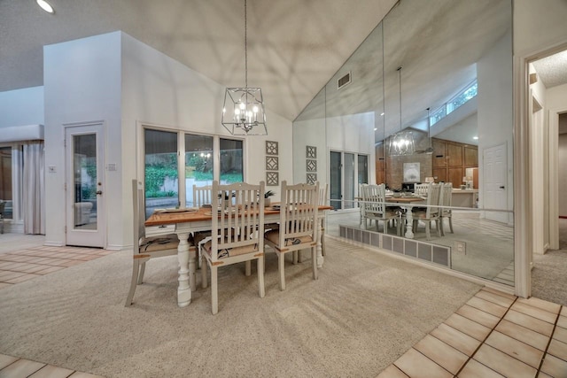 dining area with an inviting chandelier, light colored carpet, and high vaulted ceiling