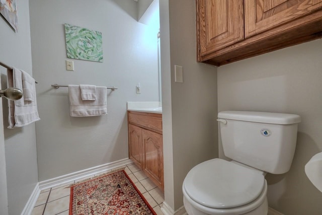 bathroom with tile patterned floors, vanity, and toilet