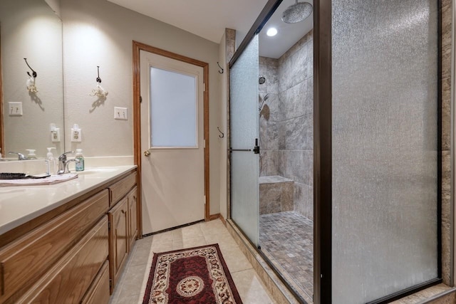 bathroom with tile patterned flooring, vanity, and an enclosed shower