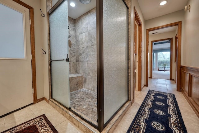 bathroom with tile patterned floors and a shower with shower door