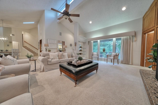 living room featuring a textured ceiling, ceiling fan with notable chandelier, light carpet, and high vaulted ceiling